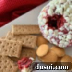 Crimson Velvet Cheese Bomb 11 Red Velvet Cheese Ball on a white platter with cookie