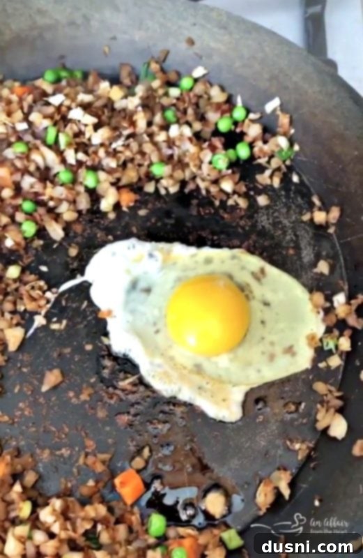 Cauli Power Stir-fry 6 Egg being scrambled in a skillet for Cauliflower Fried Rice