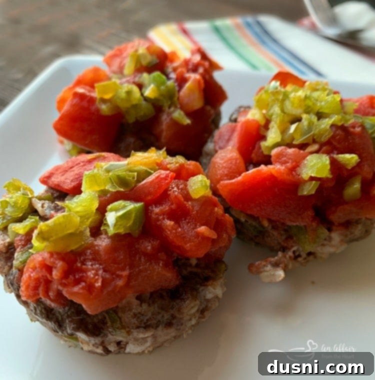Stuffed Pepper Meatloaf Minis, baked in a muffin tin, garnished with fresh herbs