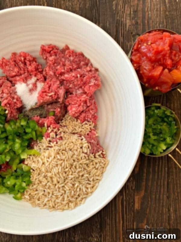Bowl of ground beef and chopped bell peppers, before mixing