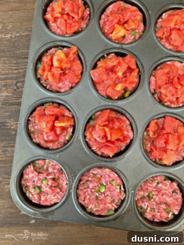 Meatloaf mixture pressed into muffin tins