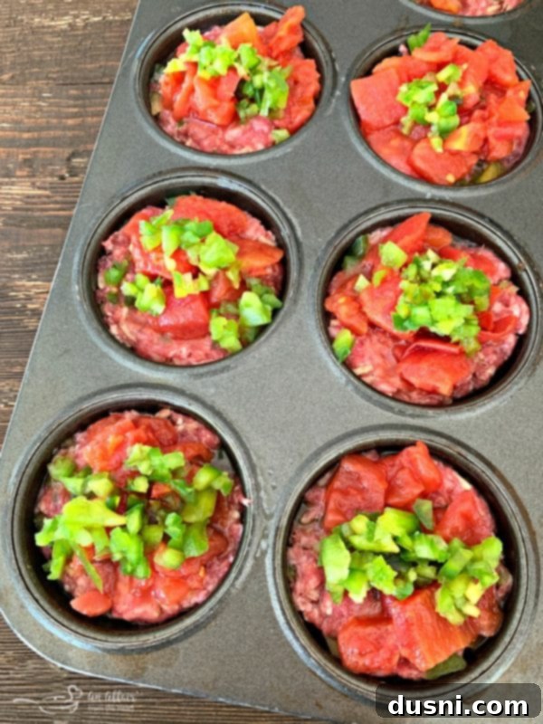 Meatloaf minis topped with diced tomatoes and bell peppers