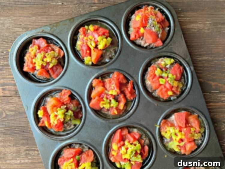 Baked Stuffed Pepper Meatloaf Minis in a muffin tin, fresh from the oven