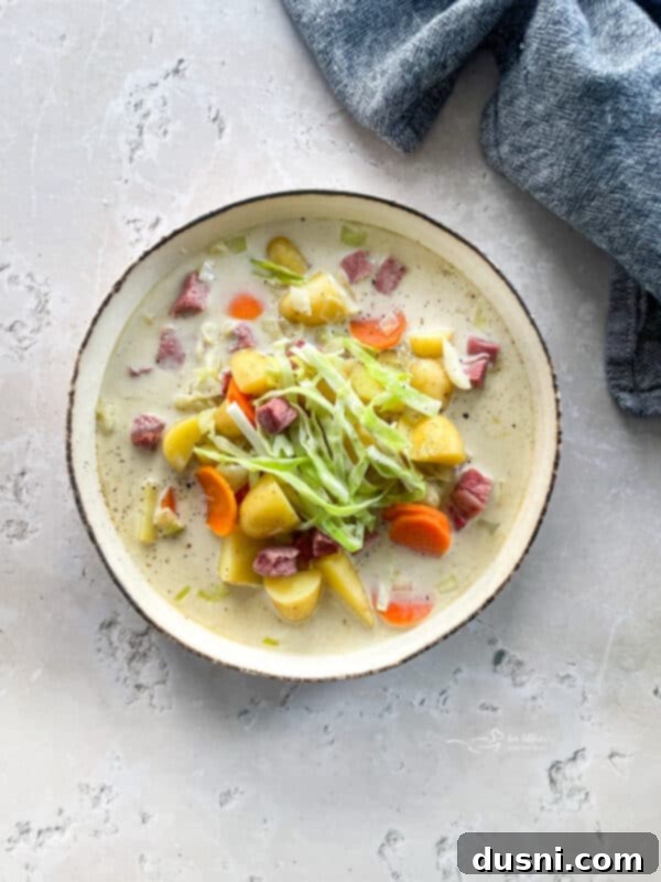 Corned Beef and Cabbage Comfort Soup 13 Creamy Corned Beef & Cabbage Soup in a white bowl