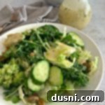 Bright Greens with Zesty Lemon Thyme Vinaigrette 13 Green Salad with Lemon Thyme Vinaigrette on a white plate