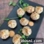 Overhead of Reuben Wonton Purses on a black serving plate