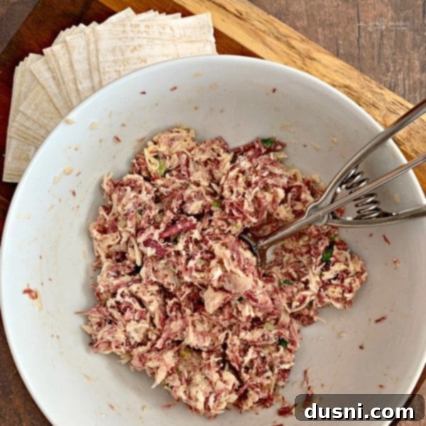Mixing the Reuben Wonton Purses filling ingredients in a bowl