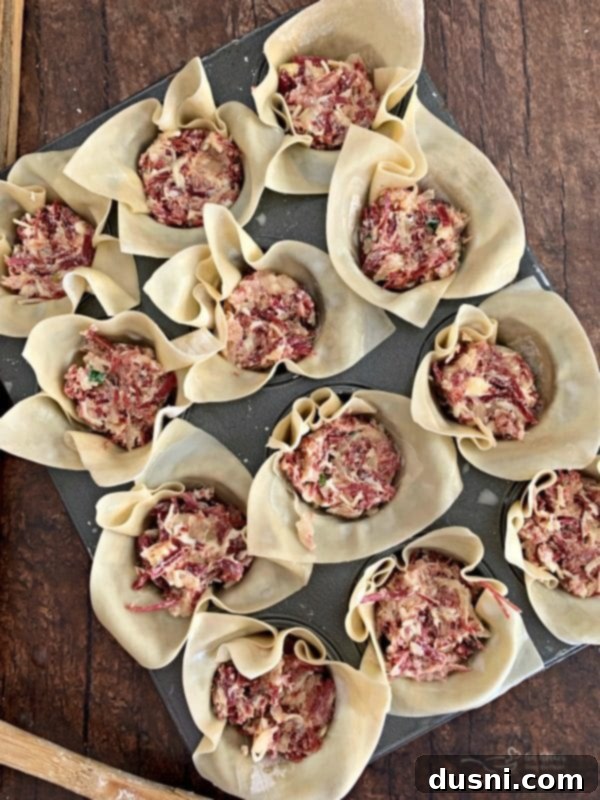 Pressing wonton wrappers into a mini muffin tin