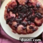 Caramelized Blueberry Upside-Down Rolls 15 overhead of Blueberry Sweet Rolls on a white serving plate