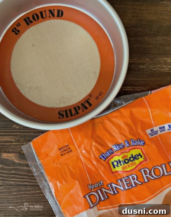 Caramelized Blueberry Upside-Down Rolls 6 Blueberry Sweet Rolls: A close-up view of dinner rolls coated in butter and brown sugar, ready for baking with blueberry pie filling.