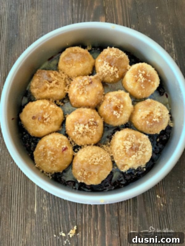 Caramelized Blueberry Upside-Down Rolls 8 Blueberry Sweet Rolls: Dough balls, coated in butter and brown sugar, are carefully placed on top of the blueberry pie filling in the cake pan.