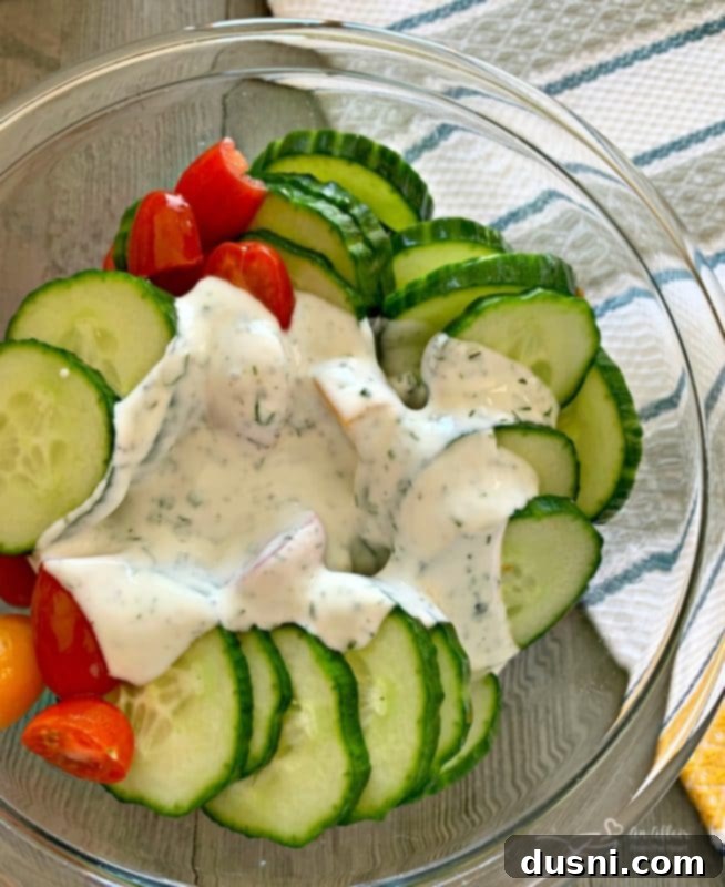 Refreshing Cucumber and Tomato Salad with Creamy Yogurt Dressing 6 Mixing Cucumber & Tomato Salad with Yogurt Dressing