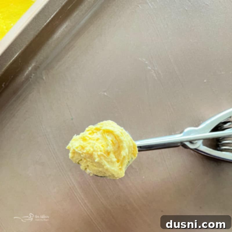 Measuring balls of lemon crinkle cookie dough