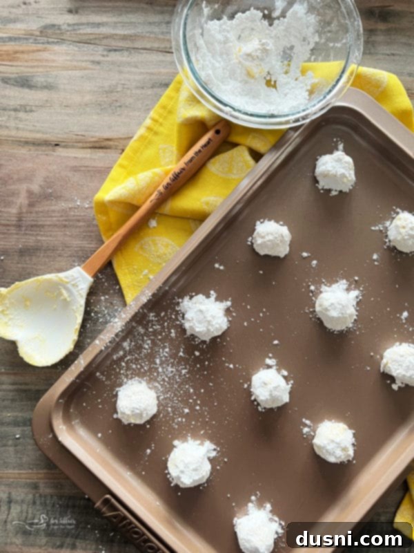 arranging lemon crinkle cookies for baking