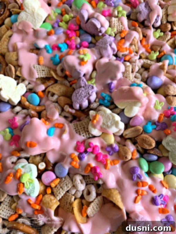 Springtime Sweet Crunch Medley 8 Snack mix spread on a baking sheet with parchment paper
