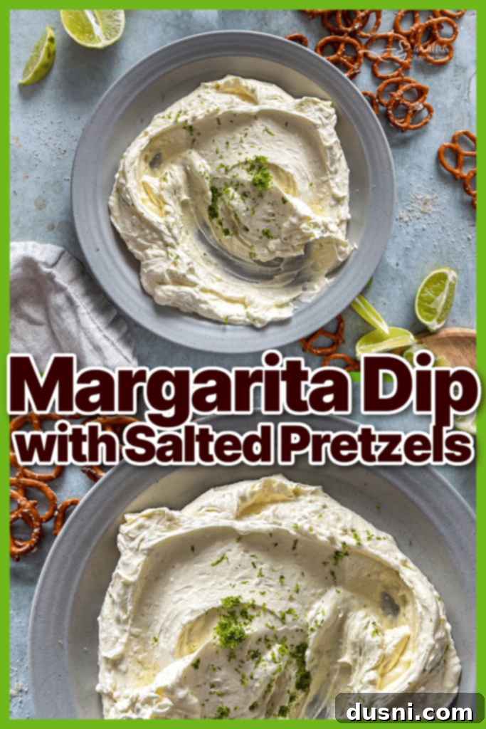 Ultimate Margarita Pretzel Dip 10 A bowl of Margarita Dip with a serving spoon, surrounded by salted pretzels, viewed from an angle.