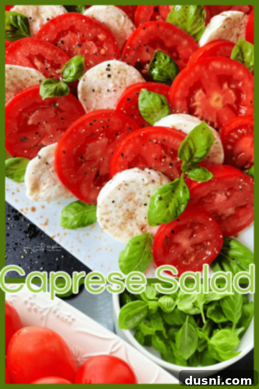 A vibrant Caprese salad, artfully arranged on a white plate, ready to be shared.