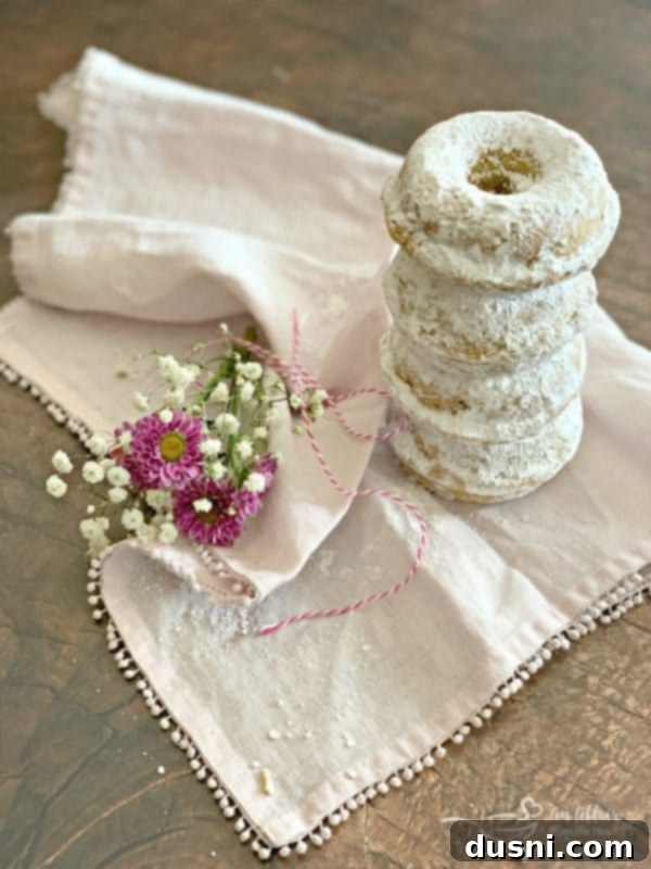 Stack of freshly baked Powdered Sugar Donuts