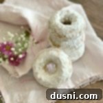 Baked Powdered Sugar Donuts stacked on a white napkin