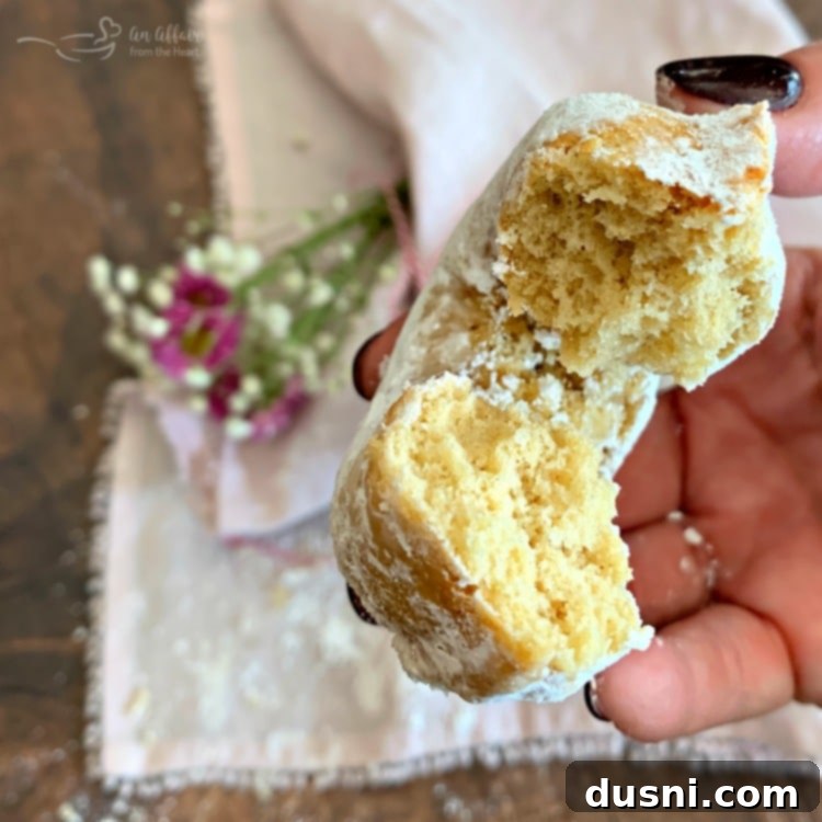 Baked Powdered Sugar Donut with a bite taken out
