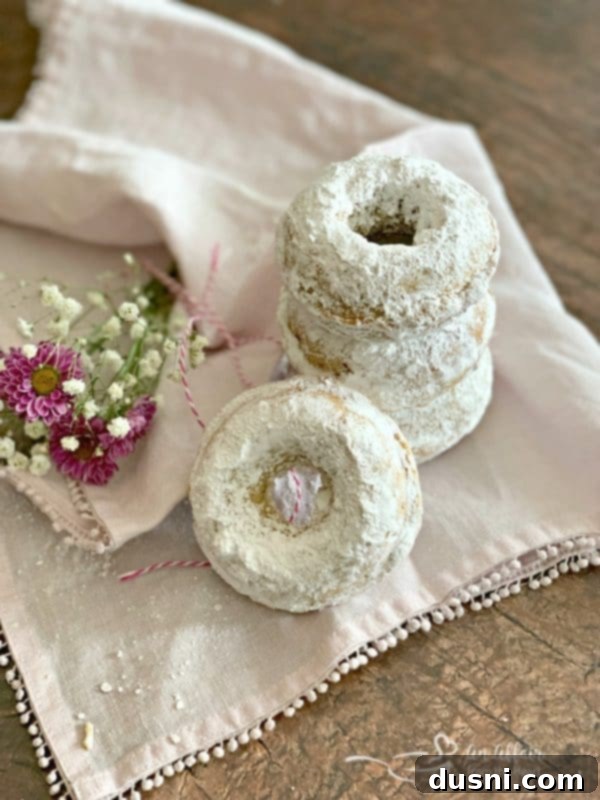 Baked Powdered Sugar Donuts, stacked and ready to eat