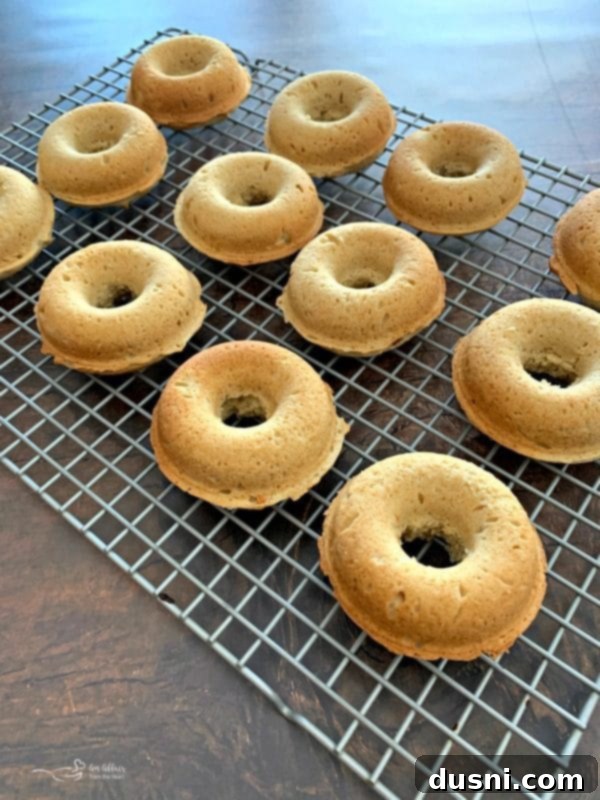 Baked Powdered Sugar Donuts cooling on a rack