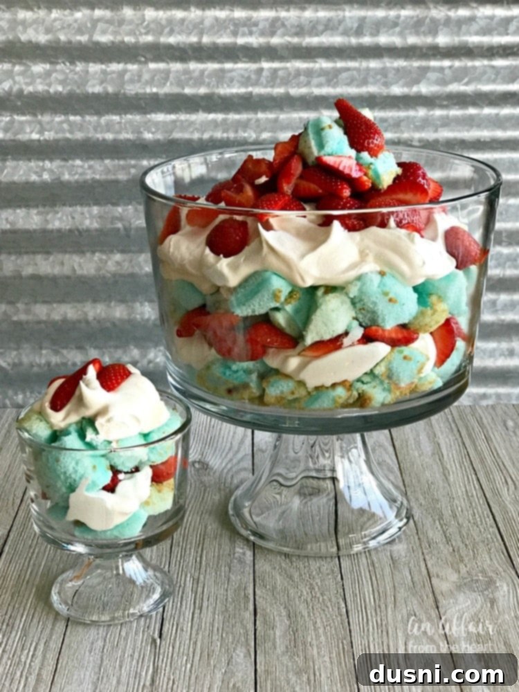 Red, White and Blue Strawberry Shortcake Trifle from An Affair from the Heart - A layered dessert with blue cake, white topping, and red strawberries