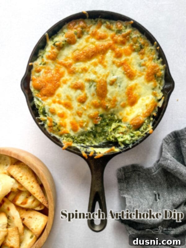 The star of the show: a beautifully baked hot spinach artichoke dip, perfect for a party appetizer.