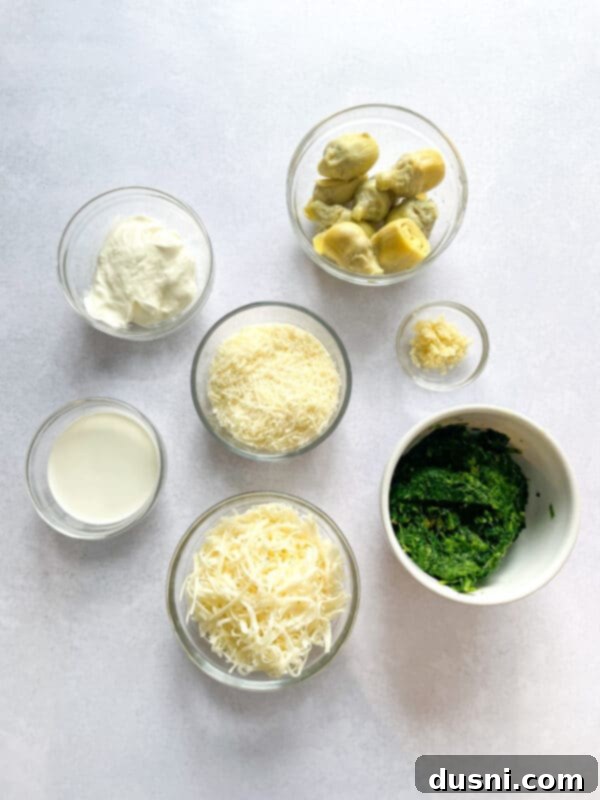 A close-up of the delicious and cheesy spinach artichoke dip, showcasing its creamy texture and golden crust.