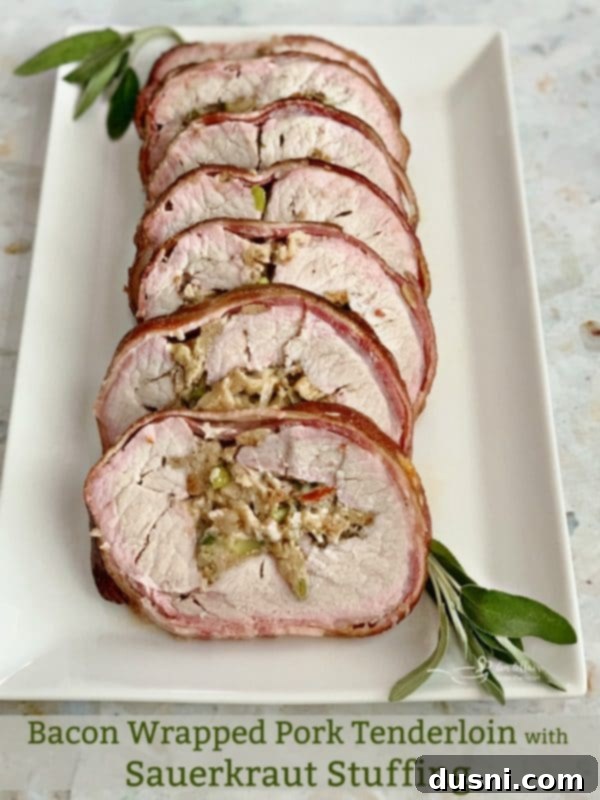 Pastırmalı Lahana Turşusu Dolgulu Domuz Kontrafile 17 Close-up of a perfectly sliced bacon-wrapped pork loin revealing the sauerkraut stuffing inside, on a white platter.