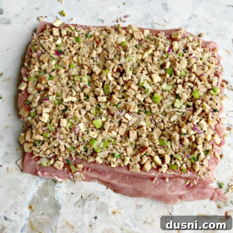 Pastırmalı Lahana Turşusu Dolgulu Domuz Kontrafile 8 Pork loin butterflied open with sauerkraut stuffing evenly spread, leaving a bare edge.