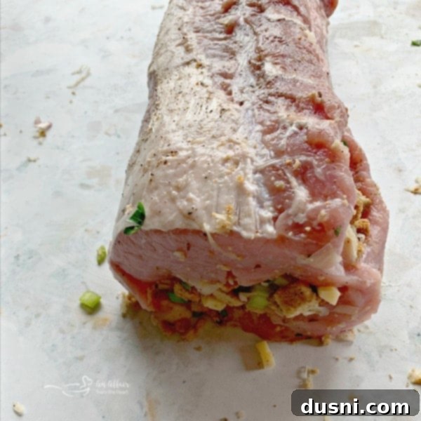 Pastırmalı Lahana Turşusu Dolgulu Domuz Kontrafile 9 Rolled pork loin with sauerkraut stuffing, showcasing the tight roll before bacon wrapping.