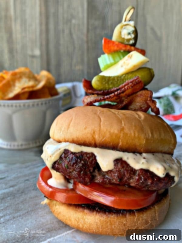 Bloody Mary's Savory Stack 2 Bloody Mary Burger with garnish on grey platter, close-up with fresh ingredients.