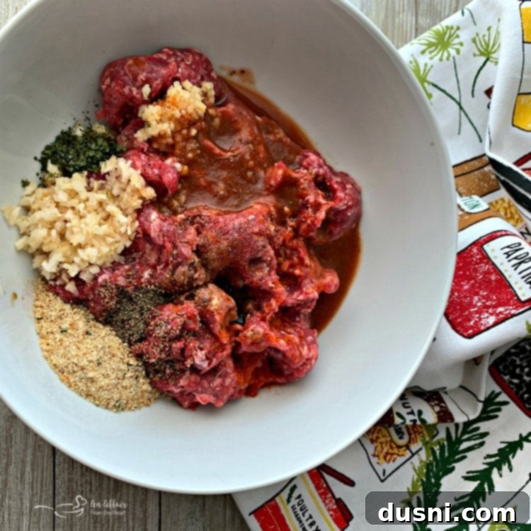 Bloody Mary's Savory Stack 7 Bloody Mary Burger ingredients mixed in a white bowl, ready to be formed into patties.