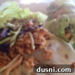 Detailed view of a buffalo chicken lettuce wrap, ready to eat.