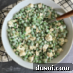 Overhead of Pea Salad with Cauliflower in a white serving bowl