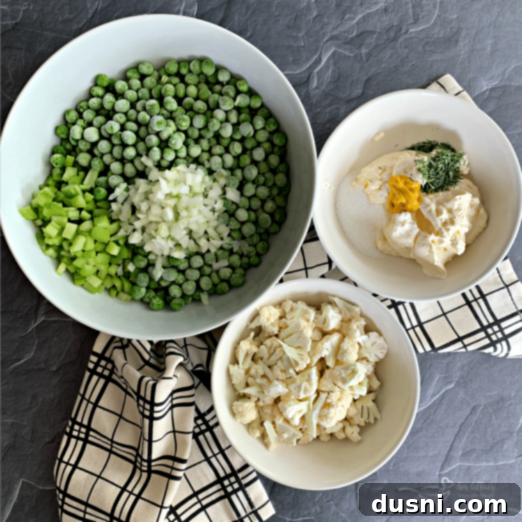 Ingredients for Pea Salad with Cauliflower being prepped on a cutting board.