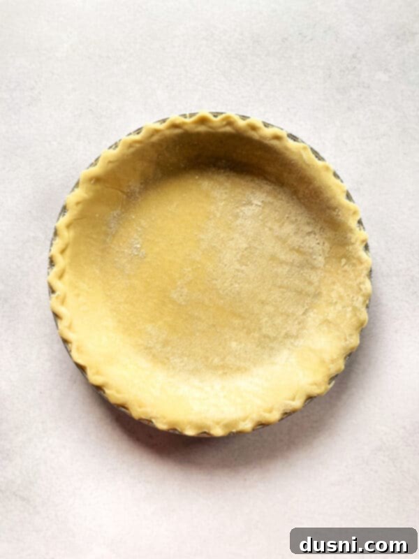 Pre-baked pie crust in a pie dish.