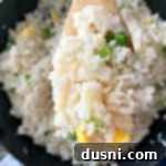 Effortless Garlic Fried Rice 12 Close up of Homemade Basic Garlic Fried Rice on a wooden spoon