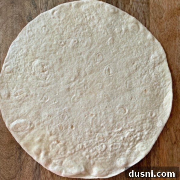 Crispy Air Fryer Taco Salad Bowls 5 Air Fryer Taco Salad Bowls prep step 1: spraying tortilla