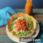 Taco Salad on a white plate and Dorothy Lynch Taco Sauce