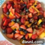 overhead of Summer Fruit Salad with Honey Lime Poppy Seed Dressing with zest