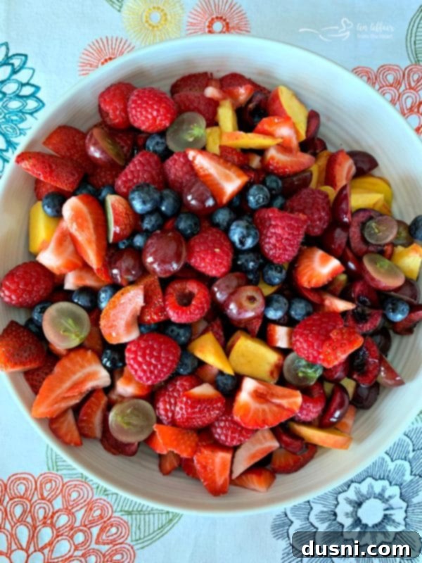 Prepared Summer Fruit Salad with Honey Lime Poppy Seed Dressing ready to be mixed