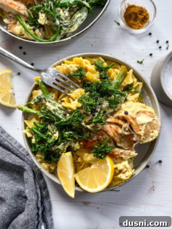 A dish of Chicken Divan next to a glass of wine