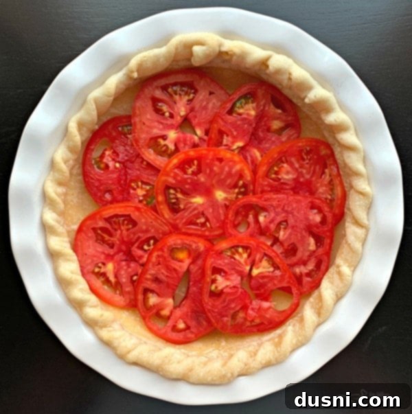 Layering tomatoes in pie crust
