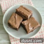 Creamy Dream Zucchini Brownies 16 overhead of Frosted Zucchini Brownies on a white plate