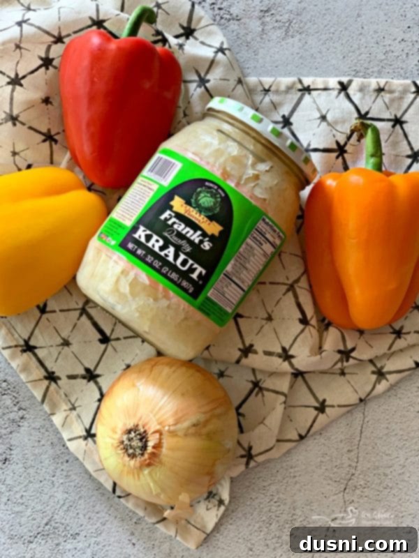 Sizzling Brat & Krautball Skewers 4 Ingredients for Grilled Bratwurst & Kraut Meatball Kabobs laid out on a table