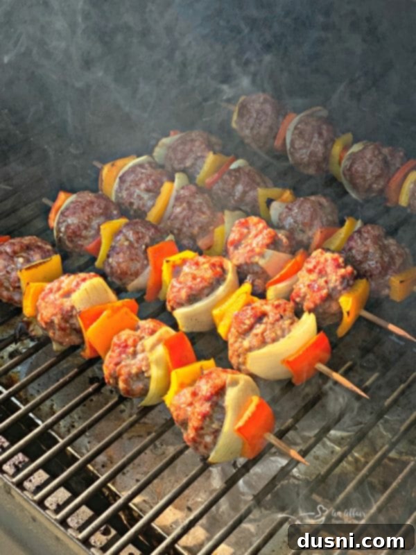 Sizzling Brat & Krautball Skewers 10 Grilled Bratwurst & Kraut Meatball Kabobs cooking on a grill