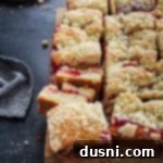 Cherry Streusel Coffee Cake 17 Close up, side view of Cherry filled coffee cake on a wooden board.
