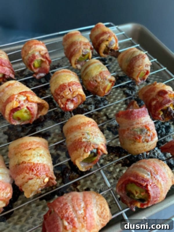 Bacon Blanketed Brussels Sprouts 10 Bacon Wrapped Hot Brussels Sprouts prepared on a cookie sheet in the oven